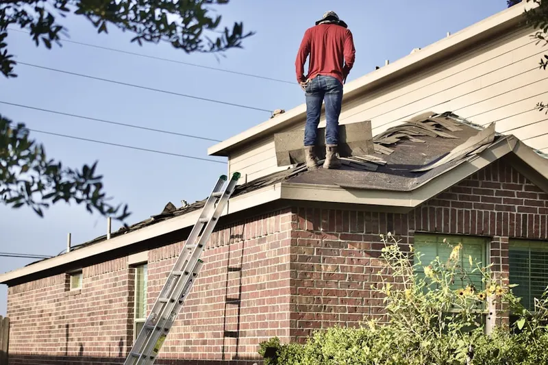 Professional roofer working on a residential roof in County Park